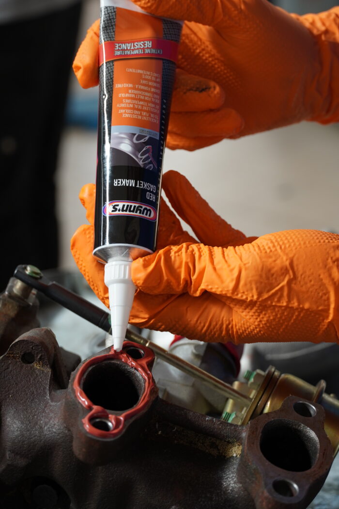 Applying red gasket maker